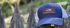 leather patch hat on a fence